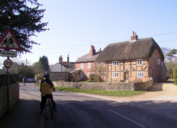 Suzanne admires the thatched cottage 