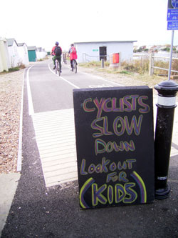 The start of the lagoon cycle path with vigilante notice 